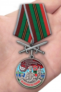 Латунная медаль За службу в Одесском пограничном отряде - вид на ладони