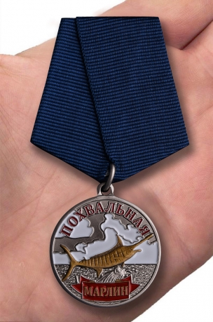 Медаль лучшему рыбаку Марлин на подставке - вид на ладони