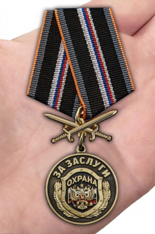 Наградная медаль За заслуги Охрана - вид на ладони